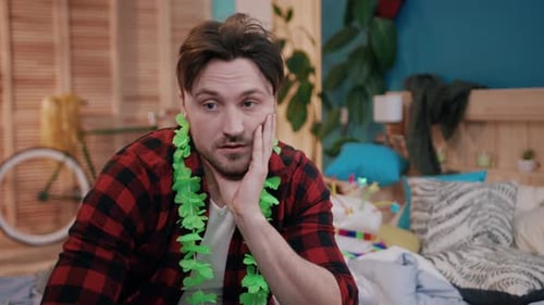 A Frustrated Man Surrounded By Party Decorations in a Bright and Colorful Room Setting