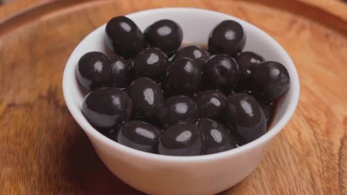 Bowl of Shiny Black Olives Close Up