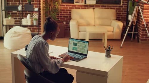 Woman Working on Laptop in Modern Home Office