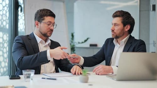 Business Professionals Finalize Money Deal with Handshake