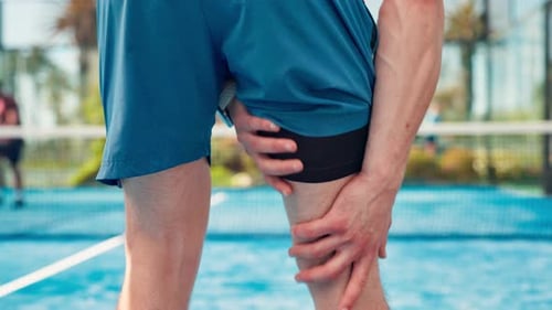 Person, hands or leg pain on padel court for joint inflammation, sport injury or muscle tension