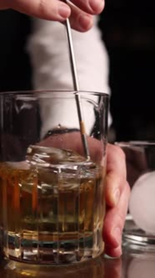the bartender prepares a popular cocktail at the bar
