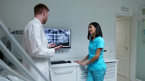Doctors Reviewing X-Ray in Modern Medical Office
