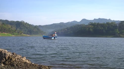 Boat Crossing the Artificial Lake Sermo Reservoir in Yogyakarta, Indonesia.