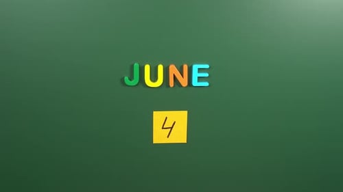 Hand sticking a sticker 4 June calendar day on school board. 4 date of June. Fourth day June
