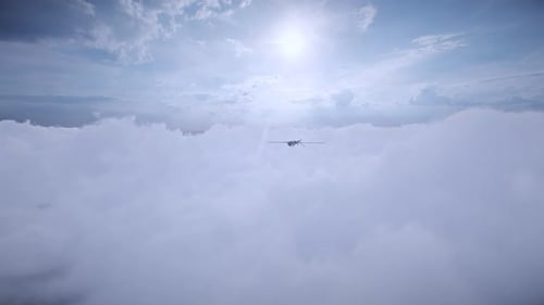 Unmanned Aerial Vehicle Flying Above Clouds in Sunny Sky