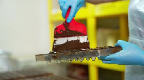 Spreading Melting Chocolate With Spatula In Mold