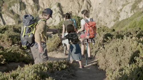 Family of Backpackers Descending Steep Mountain Slope