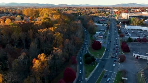Aerial of traffic on commuter highway. American lifestyle shot. Autumn fall foliage scene.