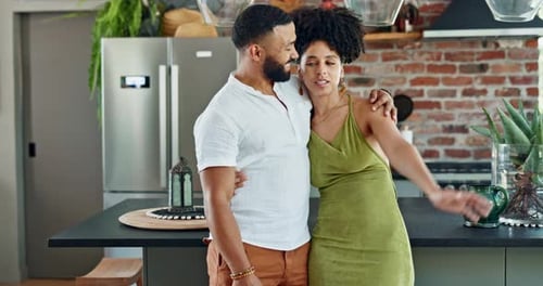 Loving Couple Embraces in Modern Home Kitchen