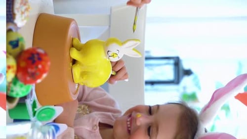 Child Decorating Easter Bunny with Help at Home