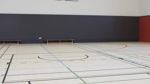Interior of indoor basketball court, in slow motion