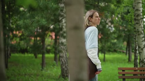 Youthful Guitarist Wandering Peaceful Musician in Nature Blonde Guitarist Explores Tranquil Park