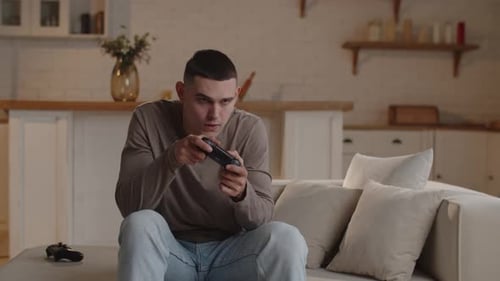 Young Adult Playing Video Game at Home