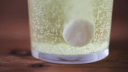 Effervescent Tablet Dissolving in Glass of Water