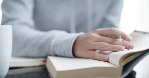 Person Reading and Writing Indoors