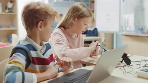 Children Program Robot Using Laptop at School