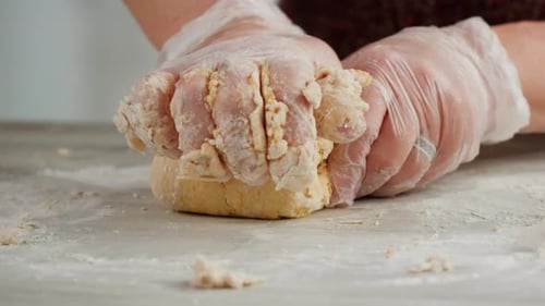 Woman Using Pasta Machine to Make Fresh Pasta Dough in the Kitchen Cooking in Italian Restaurant
