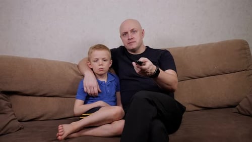 Father and Son Relaxing Together on Couch
