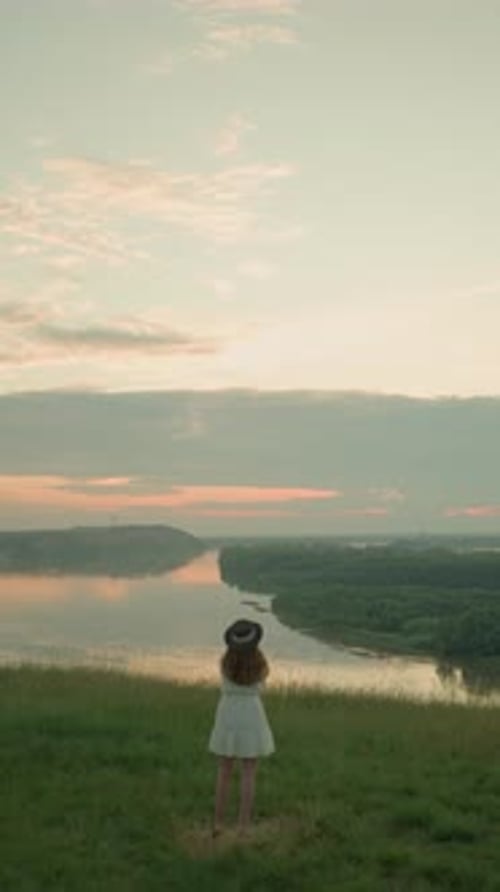 Woman in White Dress Reflecting By Tranquil Lake at Sunset