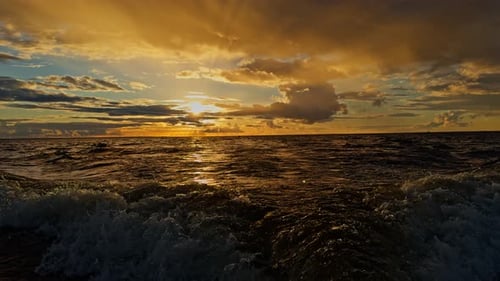 Highspeed Shooting of the Movement of a Rubber Boat at Sunset Splashes and Waves From Under the Boat