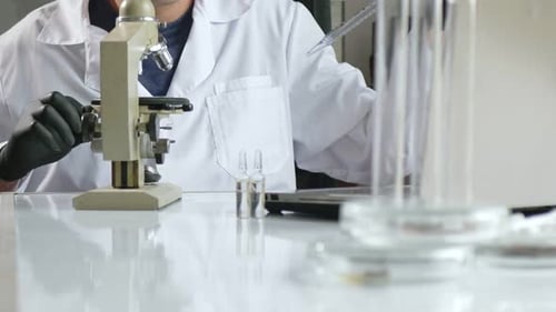 Scientist Works With Microscope in a Laboratory