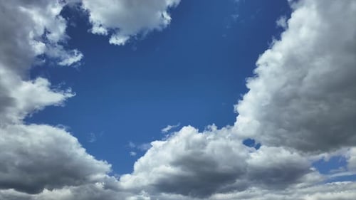 Blue Sky Filled with Drifting White Clouds