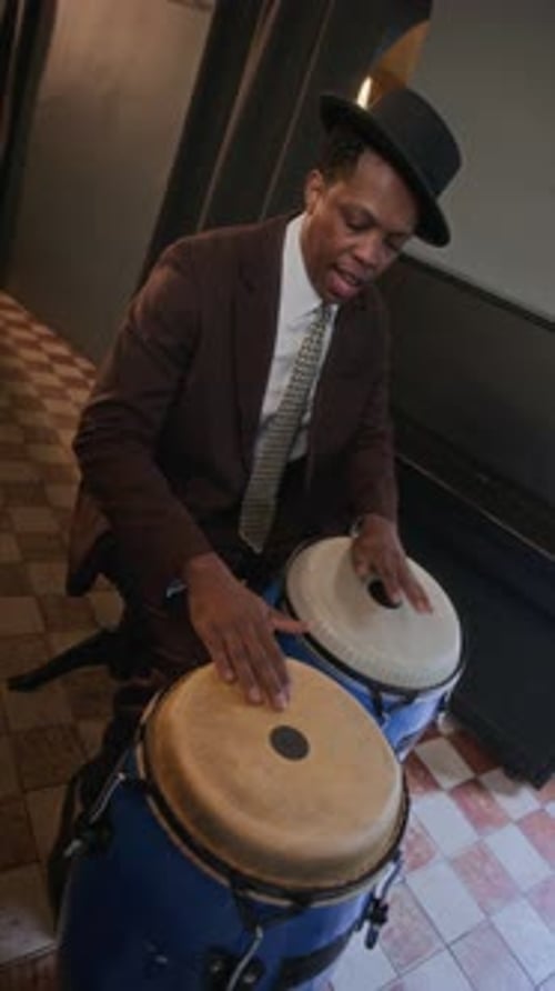 Black Man Playing Pair of Conga Drums at Jazz Bar