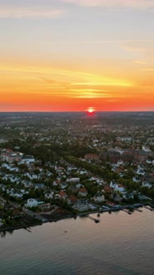 Aerial drone view of Osterbo Nord, Nordhavn harbour area at the coast of the Oresund at sunset. Vert