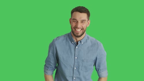 Mid Shot of a Handsome Young Man Laughing and Making Pistol Finger Gesture. Background is Green Sc