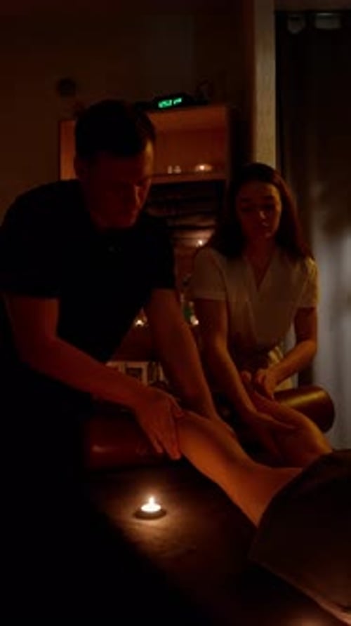 Man Giving a Foot Massage in Candlelight