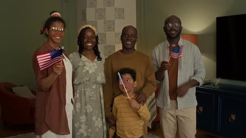 Happy Family Holding American Flags in Living Room