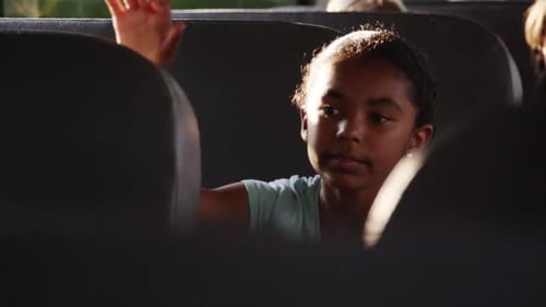 Child Riding School Bus with Other Students