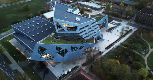 circle Drone shot of a abstract building with Intressting architecture and trees around it