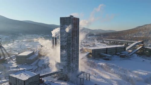 Iron Ore Mining Aerial View of Extraction Tower Iron Ore Mining Amidst Snow Contrast of Industry and