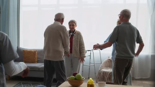 Seniors Dancing with Caregiver in Nursing Home