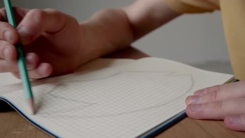 Hand Drawing in Notebook with Pencil