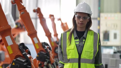 Female Engineer with Digital Tablet Examining Machine Equipment