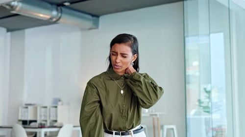 Young Woman Massages Stiff Neck at Office