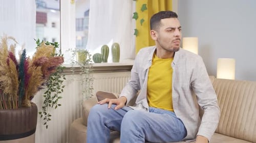 The man who smells bad odor is disturbed and disgusted.
