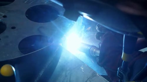 Bright sparks during industrial welding in a factory