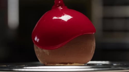 Red Glaze Poured Over Spherical Dessert