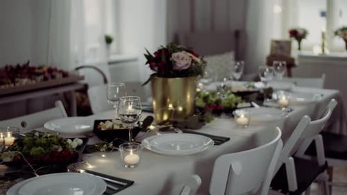 Elegant Table Setting with Candles and Flowers