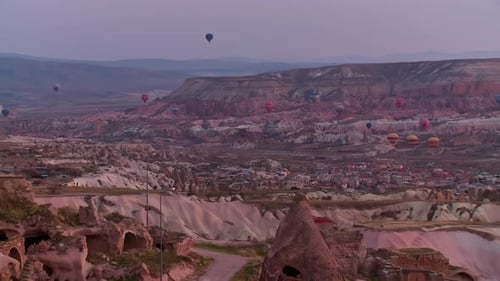 Air balloons flying over the Cappadocia valley at sunrise