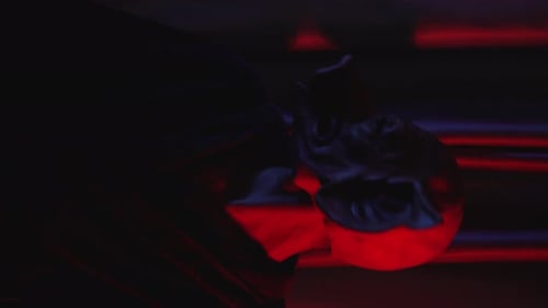 Crazy Man Looking Strange with Pig Mask in Font of Curtains Red Room with Flashiing Lights Vertical