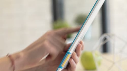 Woman Using Tablet Device Indoors During Daytime