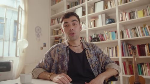 Young Adult Waving and Talking Indoors