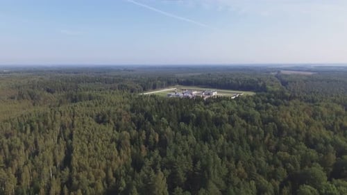 Factory Area In The Middle Of A Coniferous Forest. Aerial Flying Backwards Footage