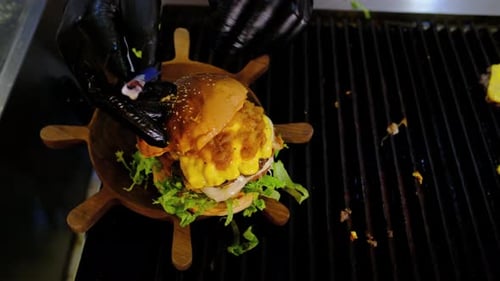 Chef Assembling Mouth-Watering Burger in Restaurant