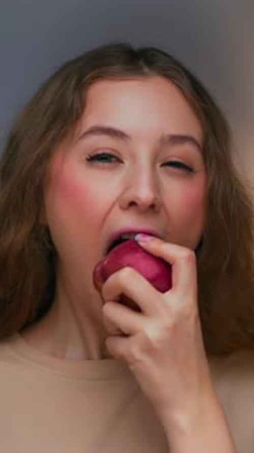 Young Woman Eating an Apple